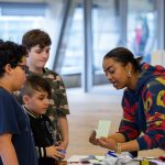 Woman and three children engaged in arts activity